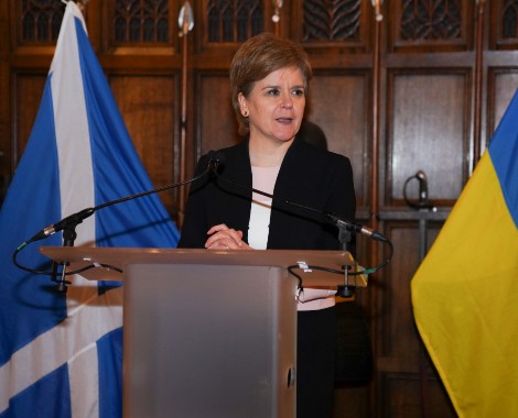 Nicola Sturgeon stood at a lectern.